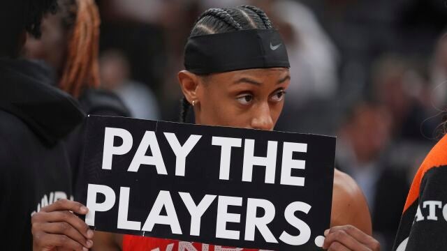 Sykes, jugadora de las Mystics, con el cartel reclamando mejoras salariales en la WNBA