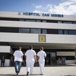 Three workers from the Hospital "Can Misses" enter the building on the island of Ibiza