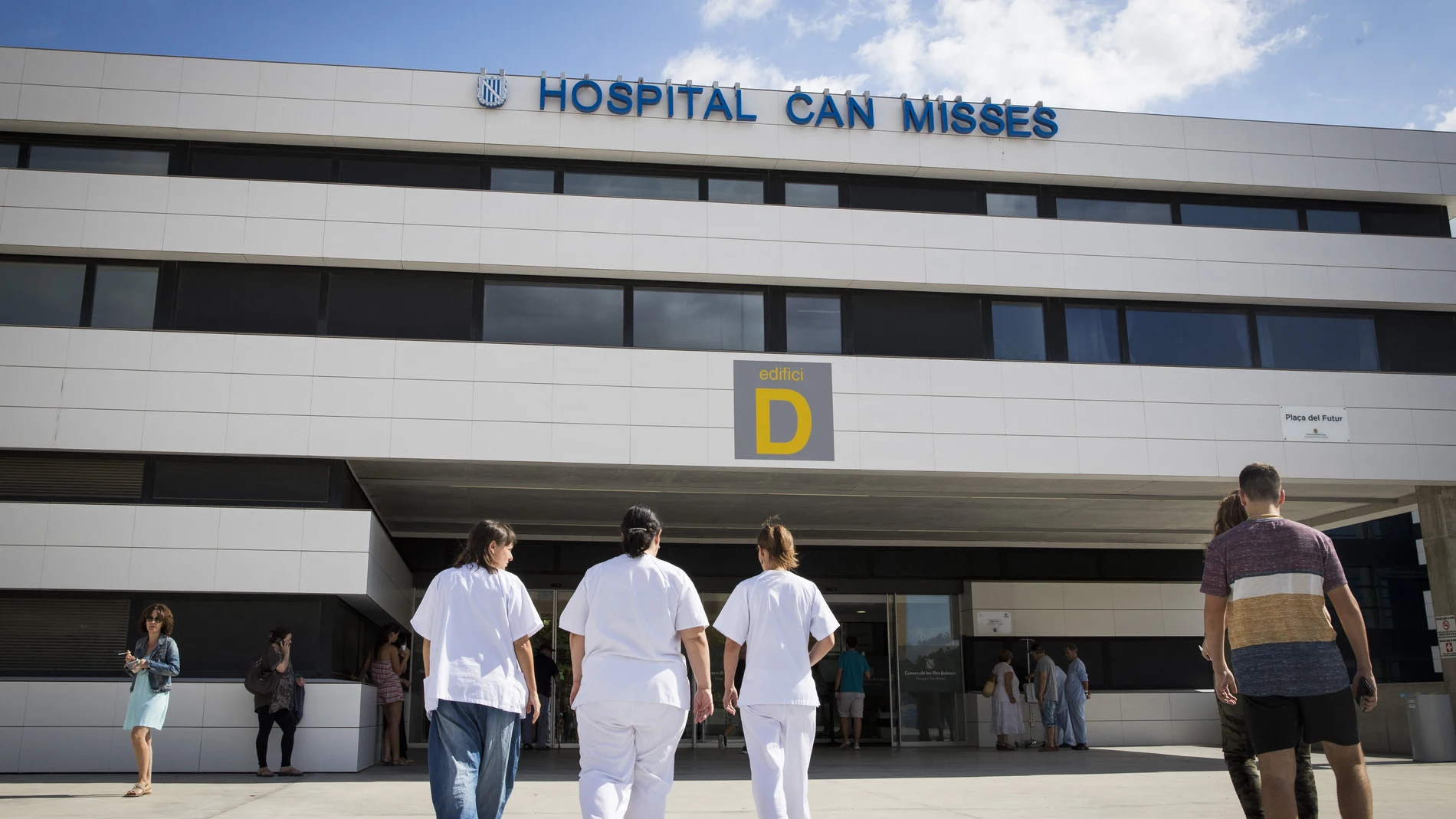 Three workers from the Hospital "Can Misses" enter the building on the island of Ibiza