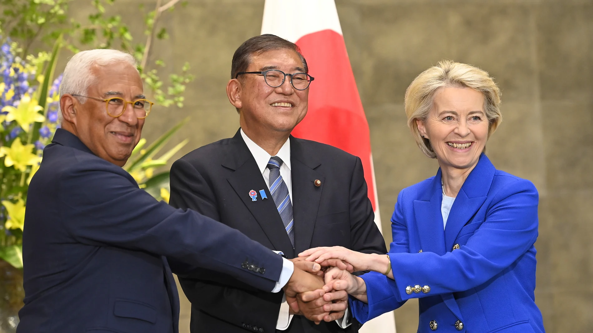 European Commission President Ursula von der Leyen, right, Japanese Prime Minister Shigeru Ishiba, center, and European Council President António Costa, left, join hands prior a meeting at the prime minister’s office Wednesday, July 23, 2025, in Tokyo Japan. (David Mareuil/Pool Photo via AP)