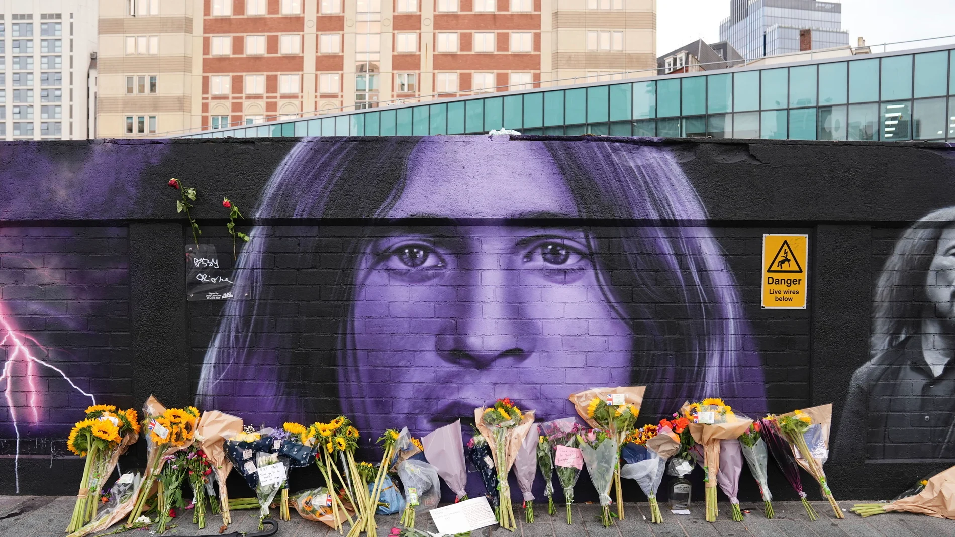 Floral tributes are left by the Sabbath Wall on Navigation Street in Birmingham, England, following the death of Black Sabbath frontman Ozzy Osbourne aged 76, Wednesday July 23, 2025. (Jacob King/PA via AP)