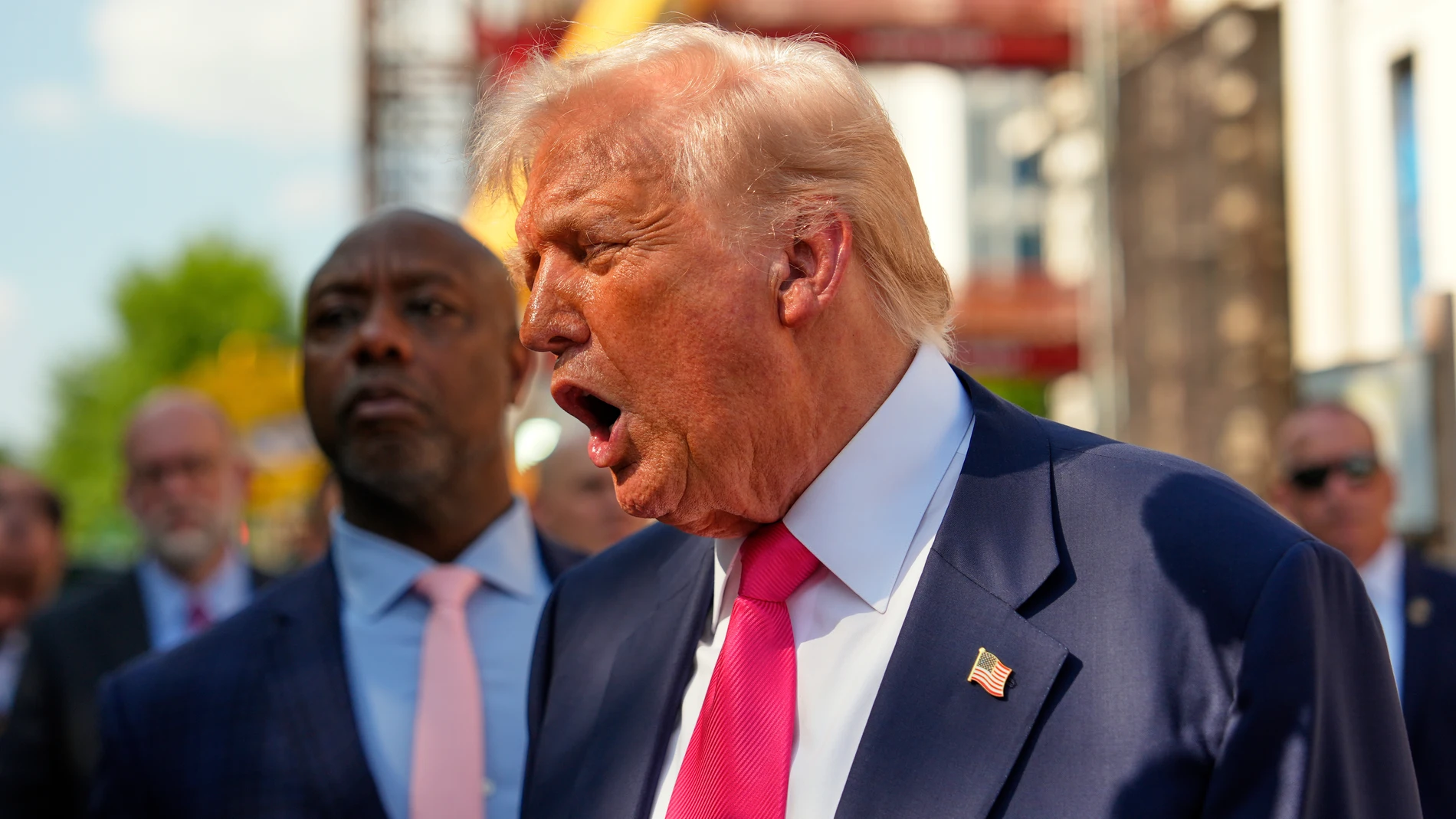 President Donald Trump speaks to reporters as Sen. Tim Scott, R-S.C., listens during a visit to the Federal Reserve, Thursday, July 24, 2025, in Washington. (AP Photo/Julia Demaree Nikhinson)