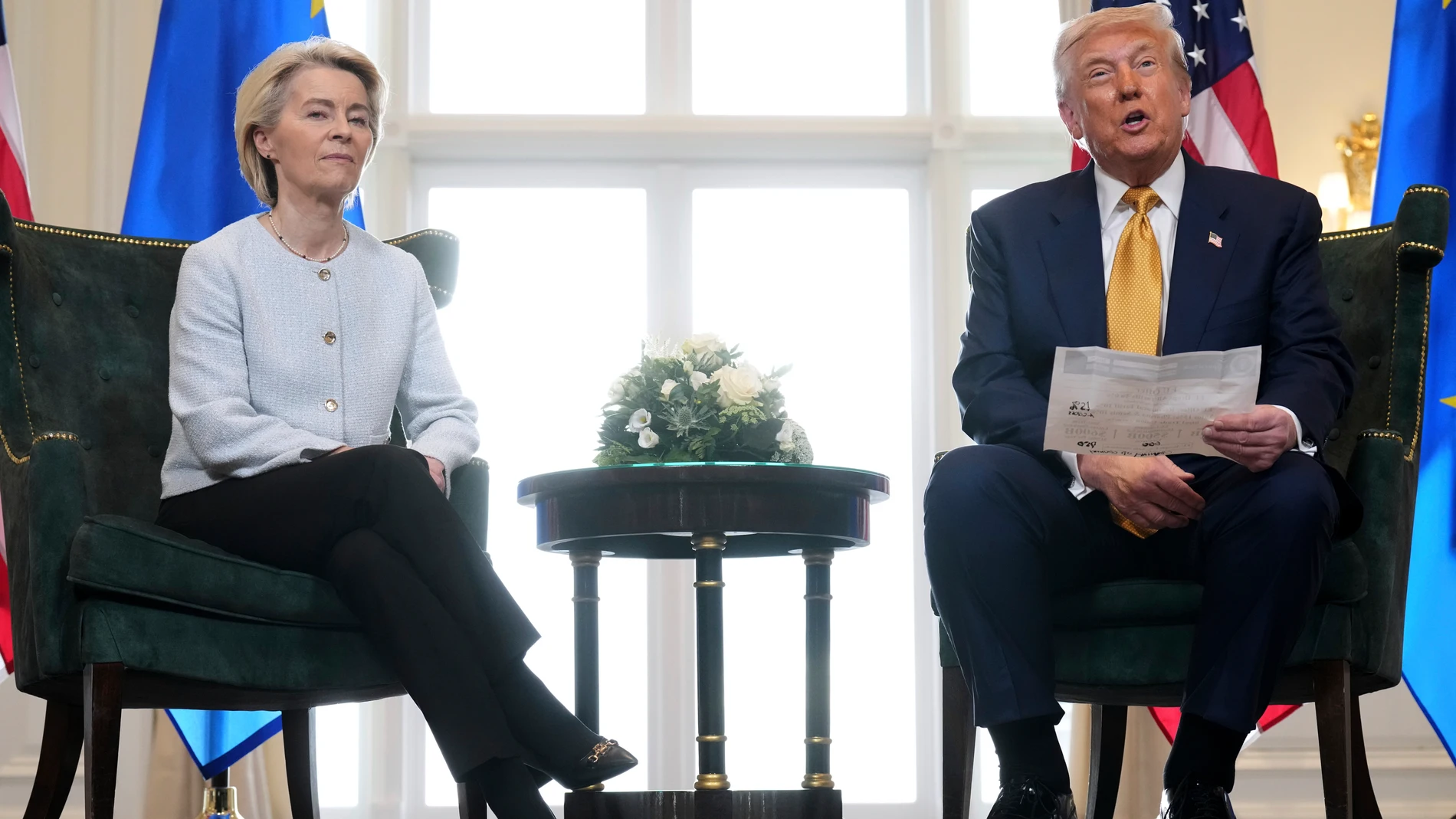 President Donald Trump reads from a paper and European Commission President Ursula von der Leyen listens after reaching a trade deal between the U.S. and the EU at the Trump Turnberry golf course in Turnberry, Scotland Sunday, July 27, 2025. (AP Photo/Jacquelyn Martin)