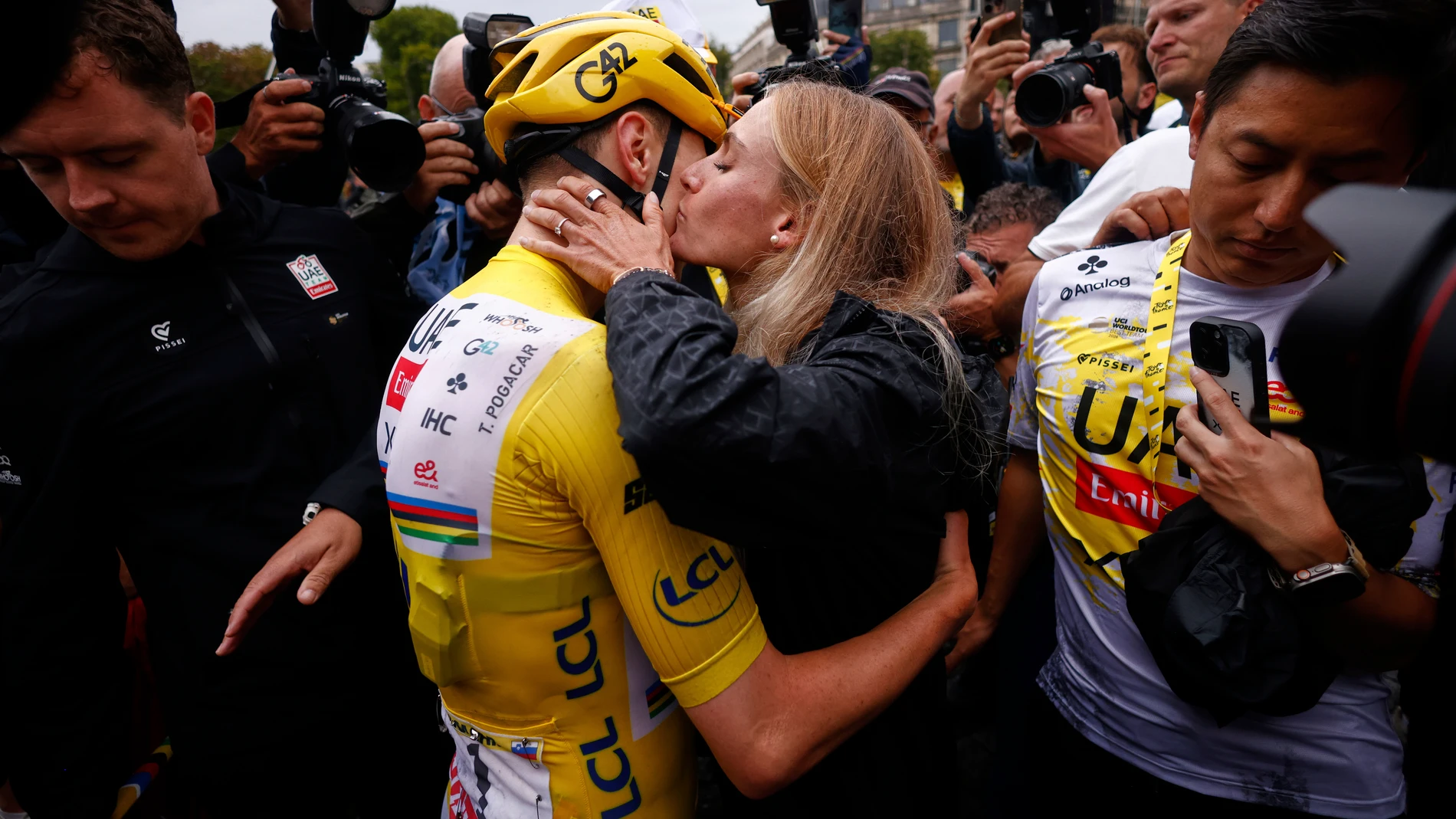 Slovenia's Tadej Pogacar, the Tour de France winner, is greeted by his partner Urska Zigart after finishing, the twenty-first stage of the Tour de France cycling race over 132.3 kilometers (82.1 miles) with start in Mantes-la-Ville and finish on the Champs-Elysees in Paris, France, Sunday, July 27, 2025. (Yoan Valat, Pool Photo via AP)