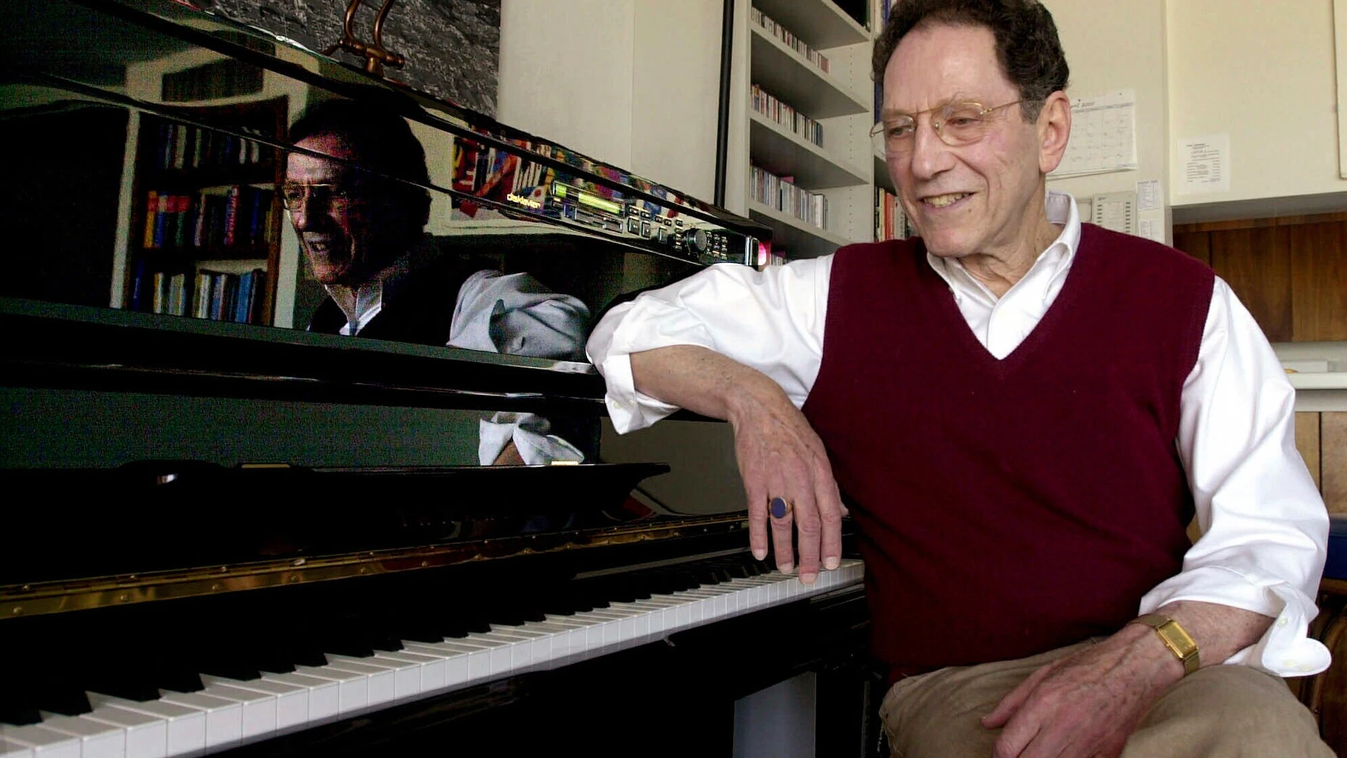 FILE - Musician Tom Lehrer sits beside the piano in his house in Santa Cruz, Calif., on April 21, 2000. (AP Photo/Paul Sakuma, File)