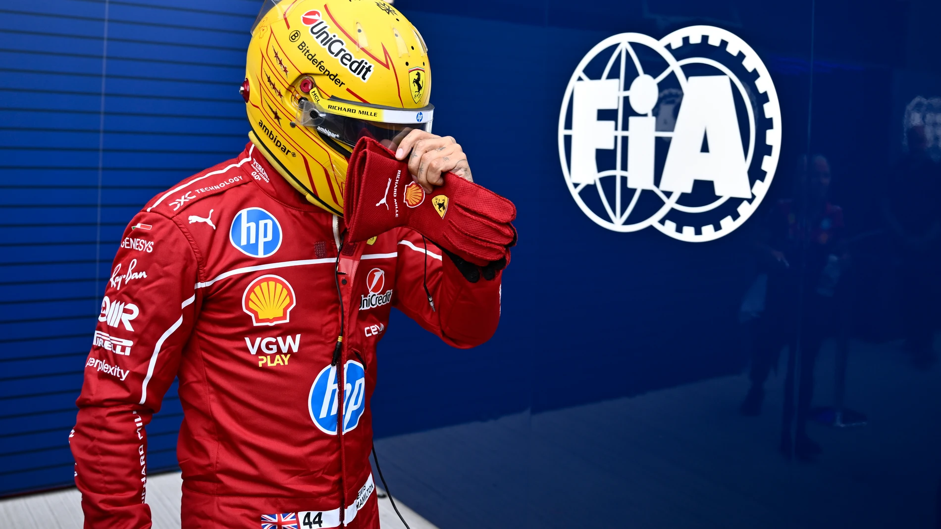 Ferrari driver Lewis Hamilton of Britain walks back to his pits after failing to complete during the qualifying session for the Hungarian Formula One Grand Prix at the Hungaroring racetrack in Mogyorod, Hungary, Saturday, Aug. 2, 2025. (AP Photo/Denes Erdos)