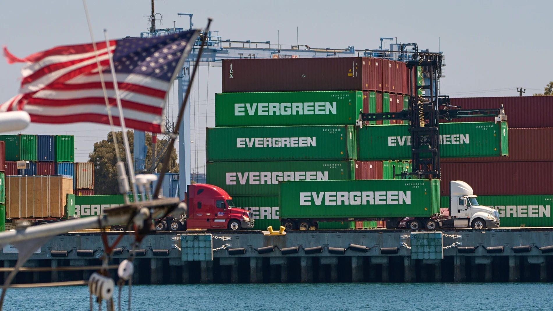Shipping containers sit stacked at the Evergreen terminal at the port of Los Angeles, Friday, Aug. 1, 2025. (AP Photo/Damian Dovarganes)