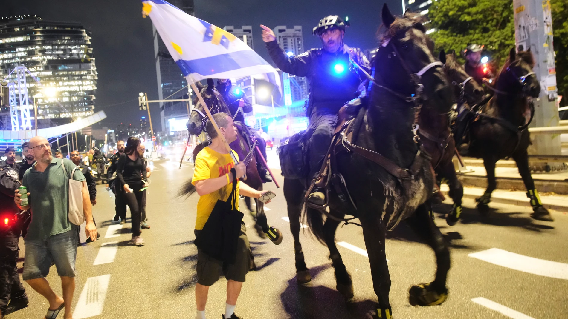 Mounted police disperse demonstrators blocking a highway during a protest demanding the release of all hostages held by Hamas in the Gaza Strip and calling for an end to the war, in Tel Aviv, Israel, Saturday, Aug. 9, 2025. (AP Photo/Ohad Zwigenberg)
