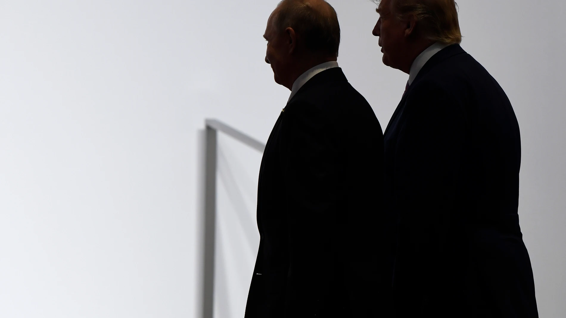 FILE - President Donald Trump and Russian President Vladimir Putin walk together at the G20 summit in Osaka, Japan, June 28, 2019. (AP Photo/Susan Walsh, File)