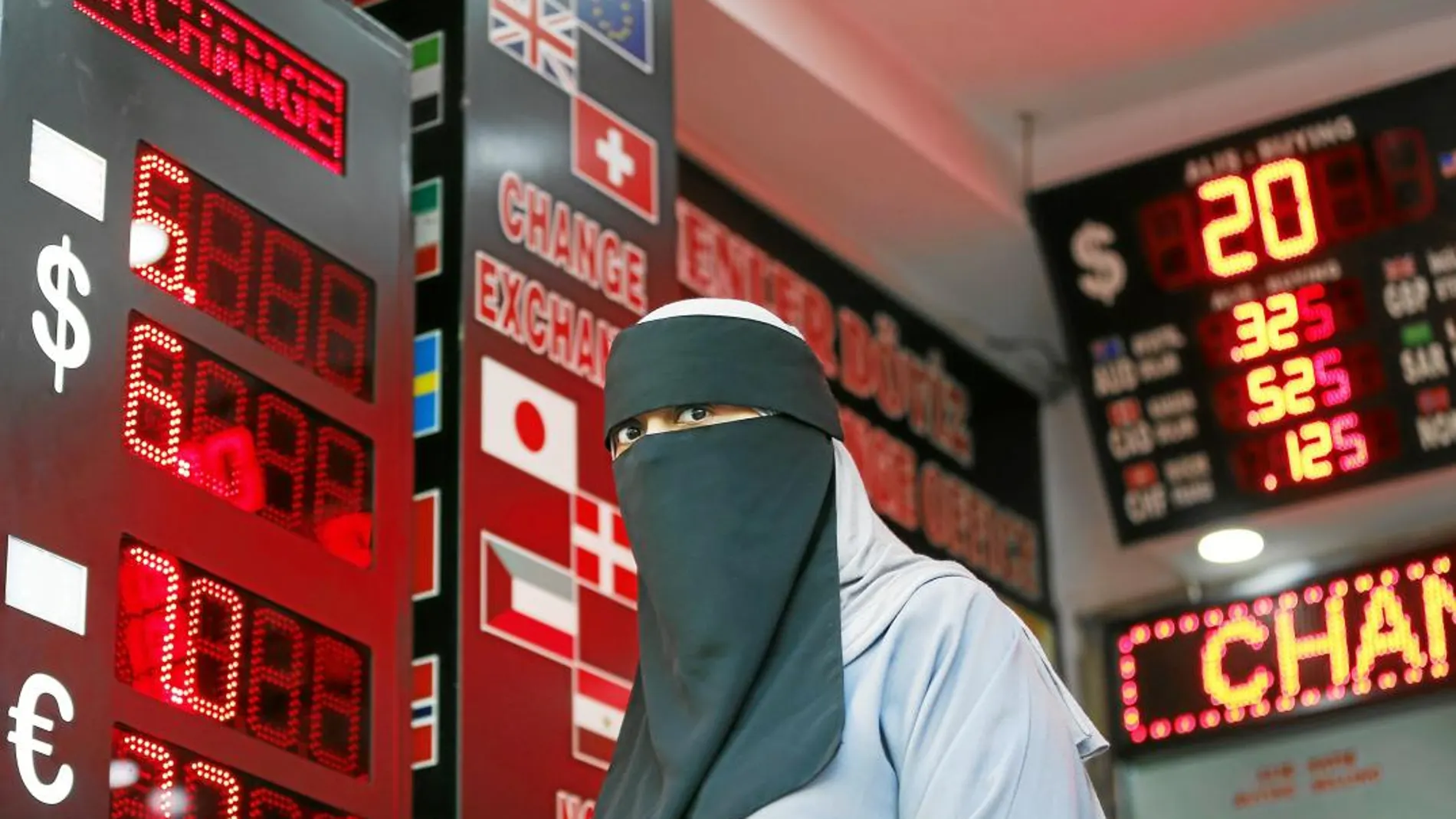 Una mujer sale de una casa de cambios en Estambul en una nueva jornada de pánico para la lira turca/Foto: AP