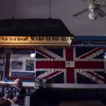 Un turista británico se sirve una cerveza en un pub ingles en Benalmádena (Málaga)