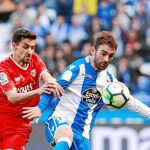 El deportivista Adrián pretende llevarse el balón ante la oposición de Navas