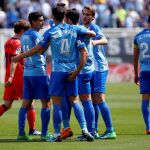 Varios jugadores felicitan al centrocampista del Málaga Club de Futbol, Adrian tras meter el primer gol a la Real Sociedad
