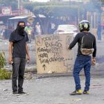 Dos jóvenes portan piedras en una barricada en los alrededores de la Universidad Politécnica de Nicaragua (UPOLI)