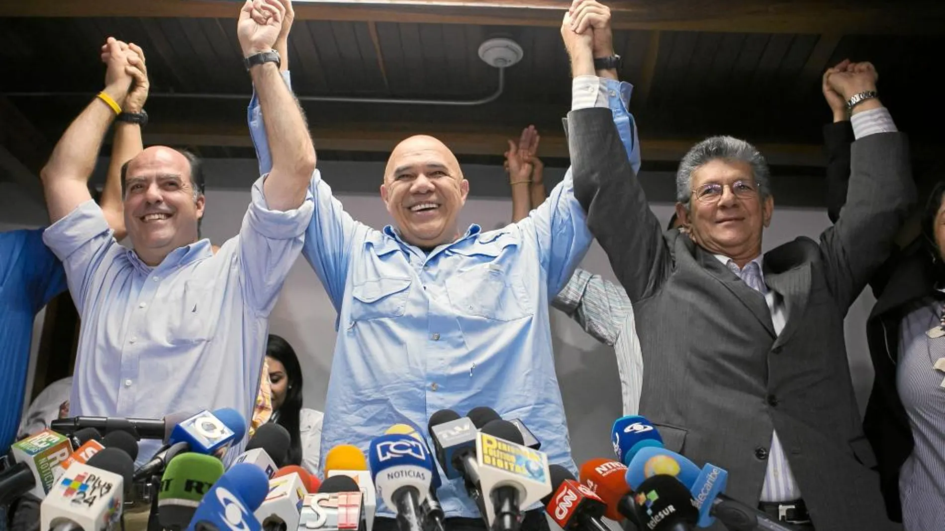 Los dirigentes opositores Jesús Torrealba (centro), Julio Borges (iqda.) y Henry Ramos (dcha.), tras una rueda de prensa, ayer, en Caracas