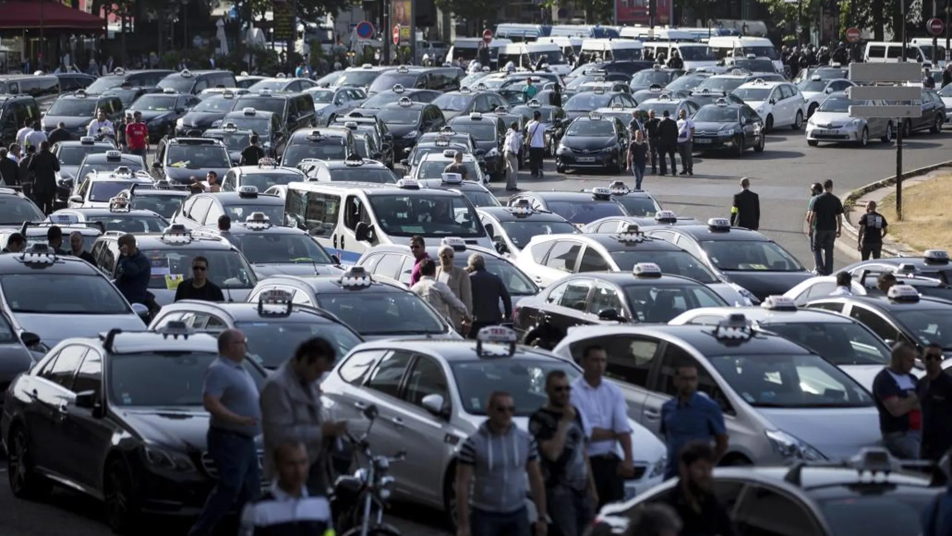 Taxistas franceses aparcan en una calle para bloquear Porte Maillot, en el oeste de París (Francia), mientras protestan contra la la empresa Uber y su servicio UberPop