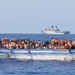 Inmigrantes viajando en un bote de madera viajando en aguas al norte de Libia