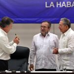 El líder de las FARC, Rodrigo Londoño Echeverri, alias "Timochenko"(c), habla con los presidentes de Cuba, Raúl Castro (d), y de Colombia, Juan Manuel Santos (i), en La Habana (Cuba)
