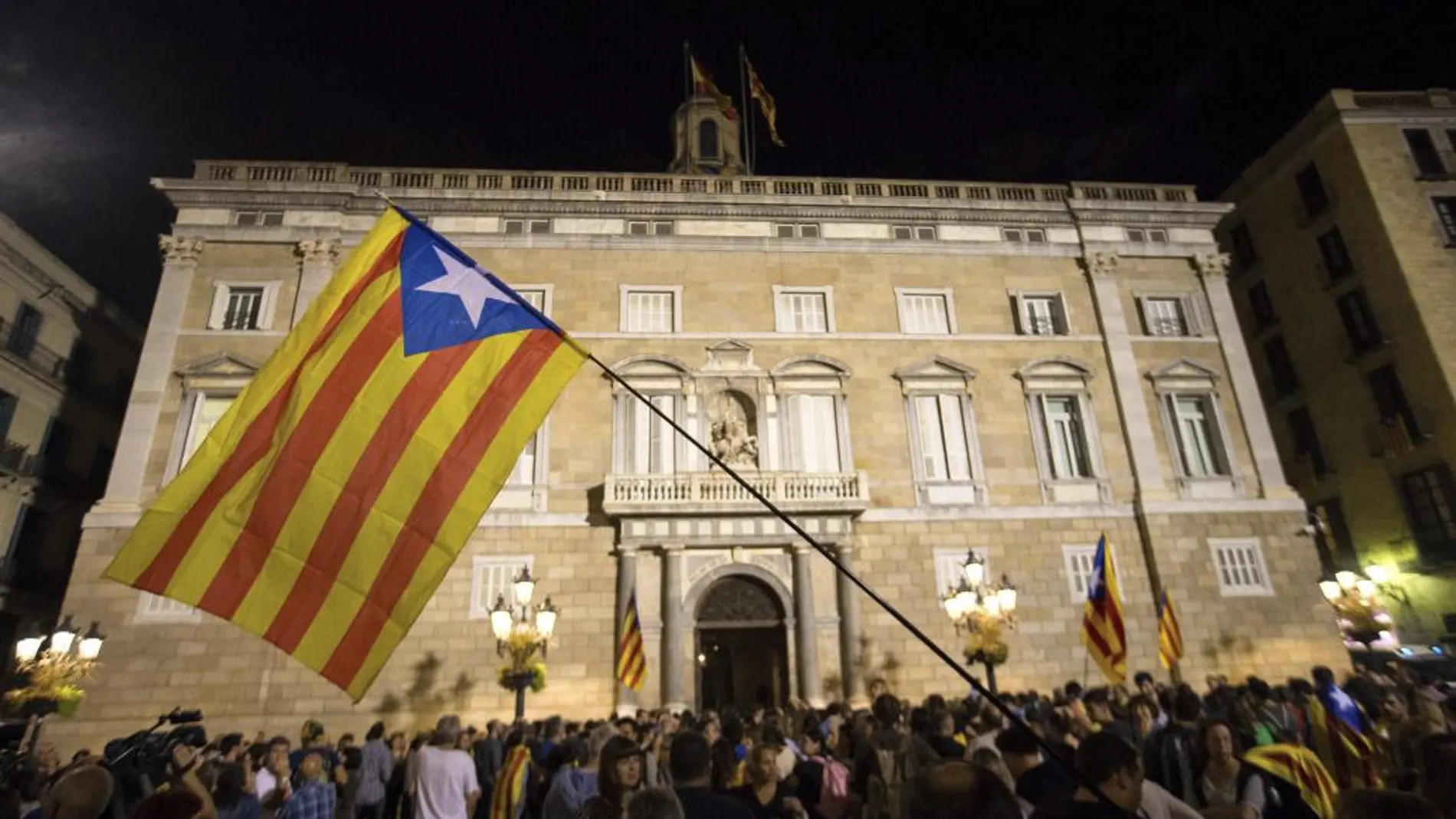 Un grupo de ciudadanos se concentran delante del Palau de la Generalitat, después que el Gobierno haya anunciado que propondrá al Senado la aplicación del artículo 155 de la Constitución/ Efe