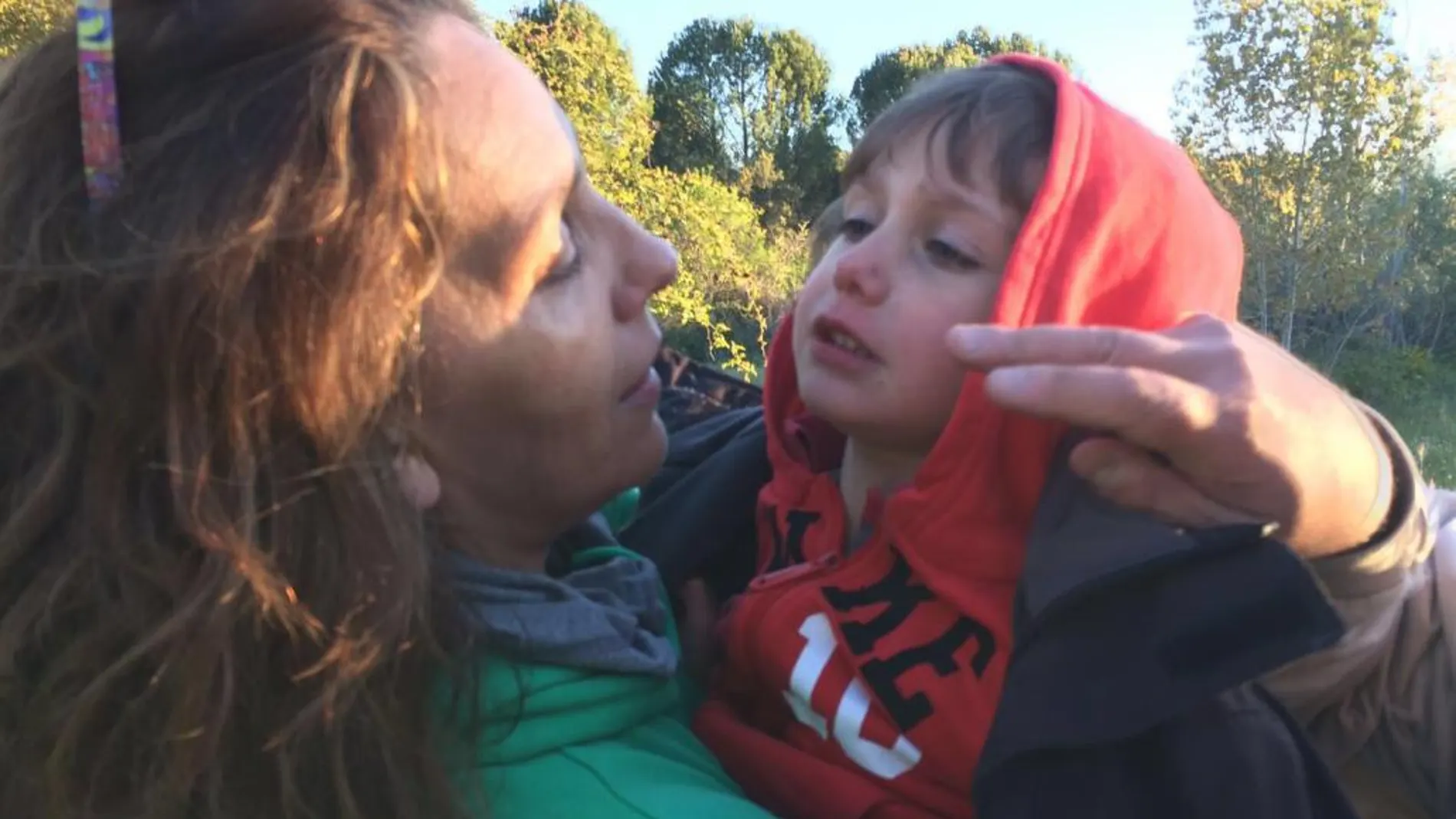 Una vecina que participó en la búsqueda coge en brazos al niño tras encontrarlo