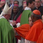 El papa ayuda a levantarse al cardenal Roger Etchegaray durante la misa tras el Sínodo