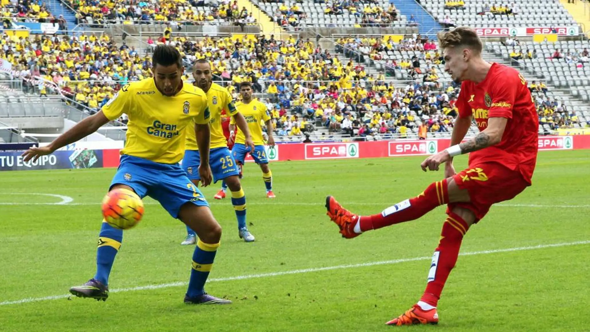 El centrocampista del Villarreal, Samu Castillejo , centra la pelota ante el centrocampista de la UD Las Palmas, David Simón