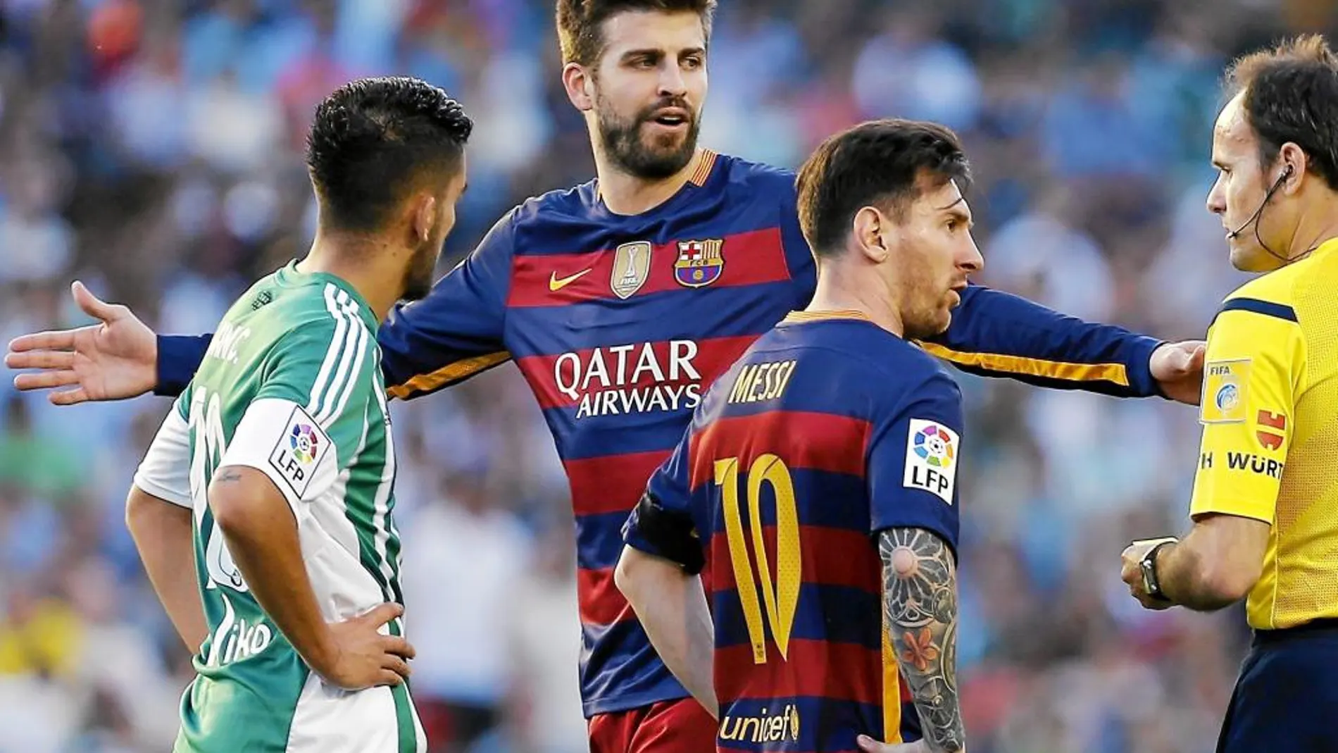 Piqué y Messi hablan al árbitro durante el partido contra el betis