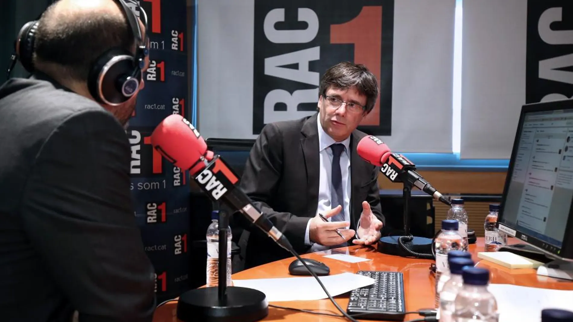 Fotografía facilitada por la Generalitat de Cataluña, de su presidente, Carles Puigdemont (d), durante la entrevista que ha concedido hoy al programa matinal "El món", de la emisora de radio RAC 1