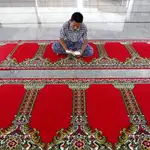 Un musulmán de la ciudad de Aceh lee el Corán mientras espera el final del ayuno en la mezquita de Darussalam, Aceh, Indonesia