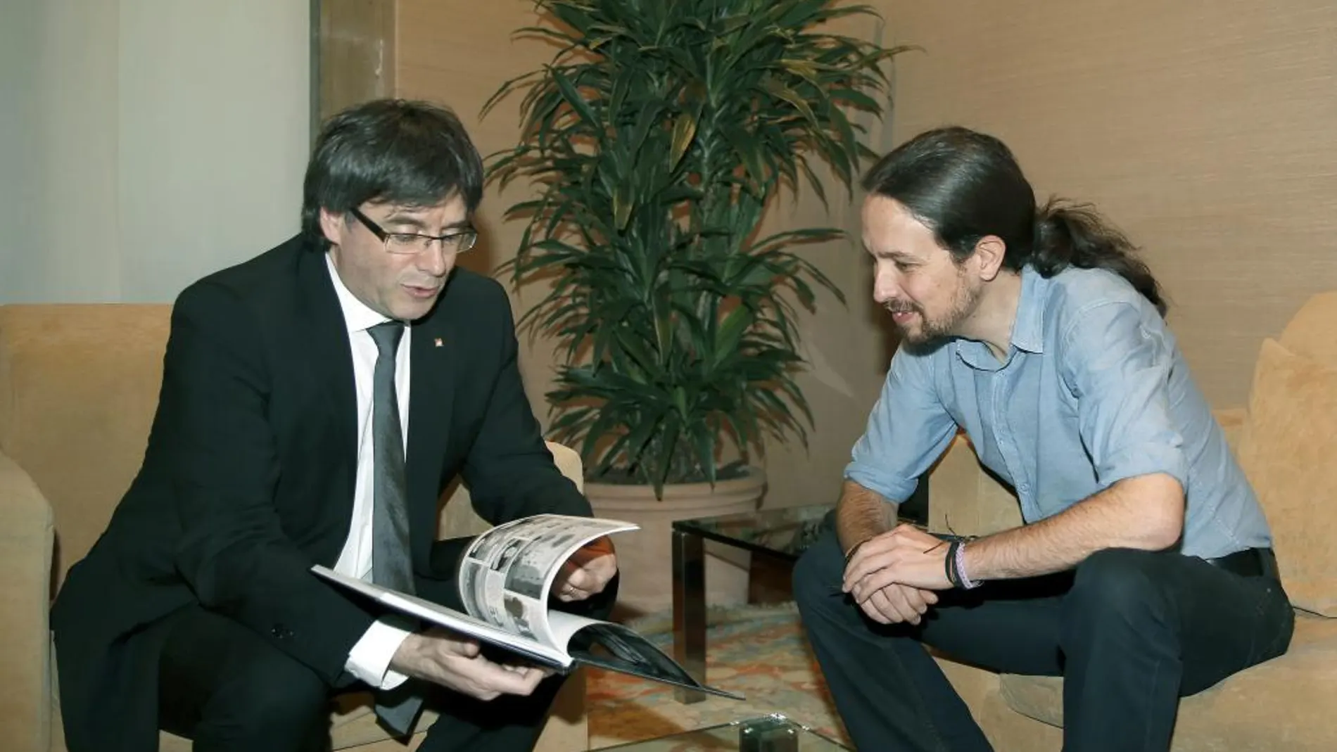 El presidente de la Generalitat, Carles Puigdemont, junto al líder de Podemos, Pablo Iglesias al que ha regalado un libro