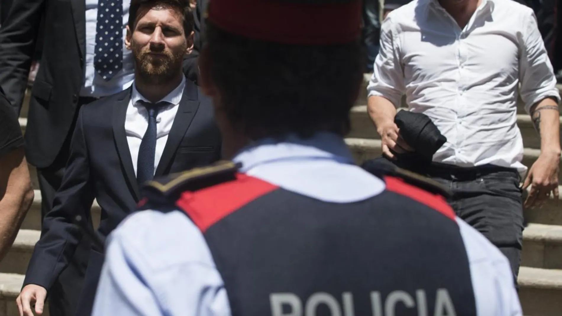 El jugador del FC Barcelona Lionel Messi (i), sale de la Audiencia de Barcelona tras declarar.