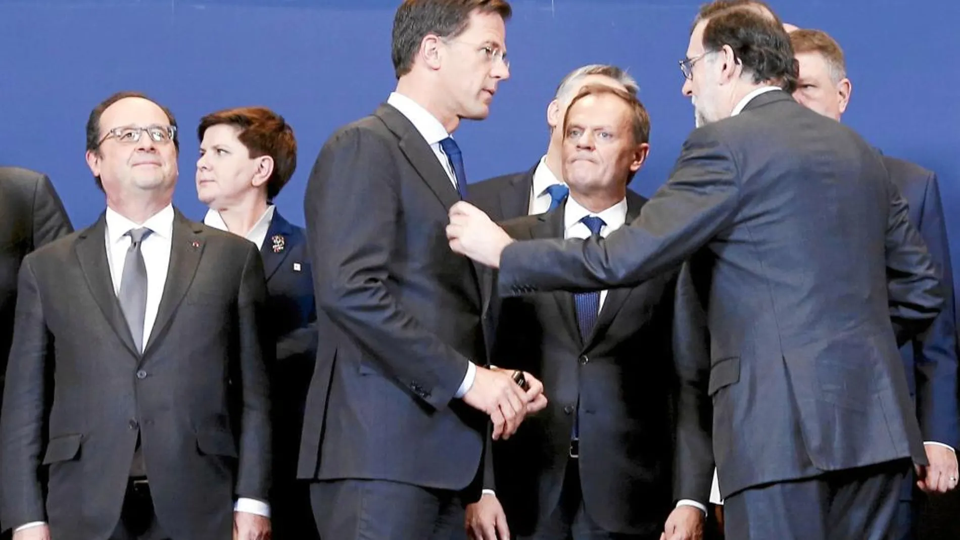 Mariano Rajoy conversa con el primer ministro holandés y presidente de turno de la UE, Mark Rutte, bajo la atenta mirada del presidente del Consejo Europeo, Donald Tusk, ayer en Bruselas