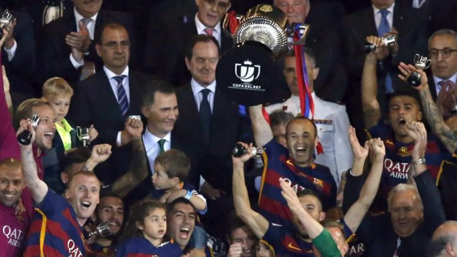 El capitán del FC Barcelona Andrés Iniesta (c), junto a sus compañeros, levanta la Copa del Rey tras vencer en la final al Sevilla FC por 2-0
