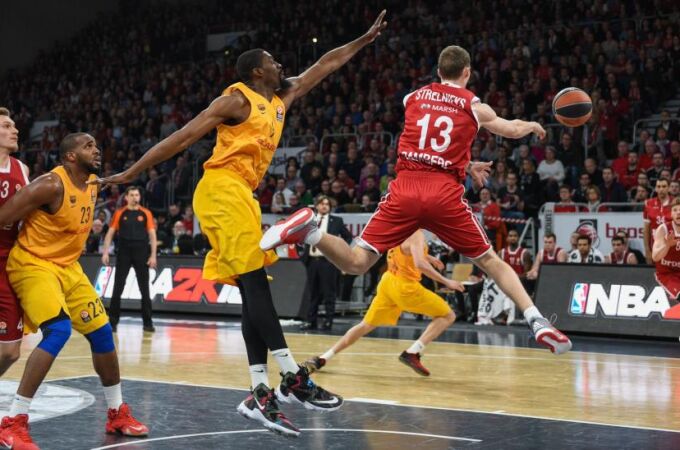 Janis Strelnieks (2d) de Brose Baskets Bamberg disputa el balón contra Shane Lawal (3i) de FC Barcelona