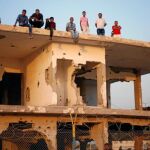 Palestinos esperan en el tejado de un edificio en ruinas en Gaza a que sus familiares vuelvan de peregrinación a la Meca