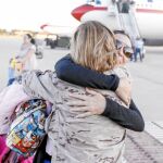Una de las españolas repatriadas se abraza con un familiar a su llegada a Torrejón de Ardoz