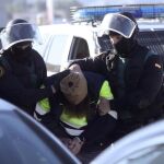 Agentes de la Guardia Civil trasladan a uno de los dos detenidos en Ceuta