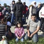 Una familia siria espera para continuar su viaje a Berlín tras su llegada a la estación de tren de Schönefeld (Alemania)