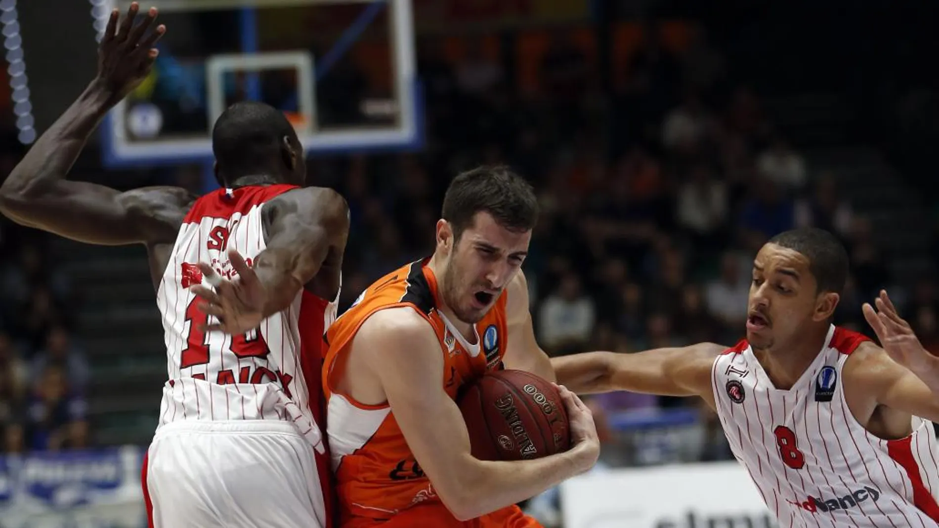 El base del Valencia Basket, Guillem Vives, se abre camino entre los jugadores del SLUC Nancy, Bandja Sy (i) y Benjamin sene, durante el partido de la sexta jornada de la fase inicial de la Eurocopa (18/11/2015)