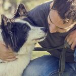 En la imagen, un hombre junto a su perro en el parque | Fotografía de archivo