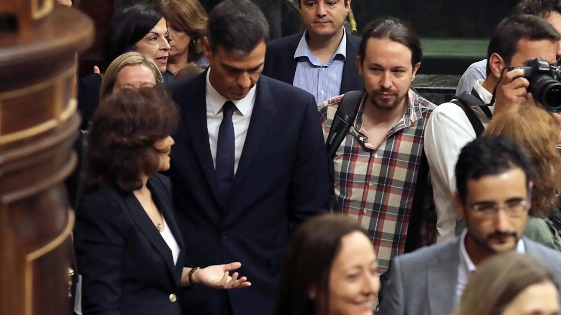 El presidente del Gobierno, Pedro Sánchez, acompañado de la vicepresidenta, Carmen Calvo y el líder de Podemos, Pablo Iglesias, a su llegada al Congreso