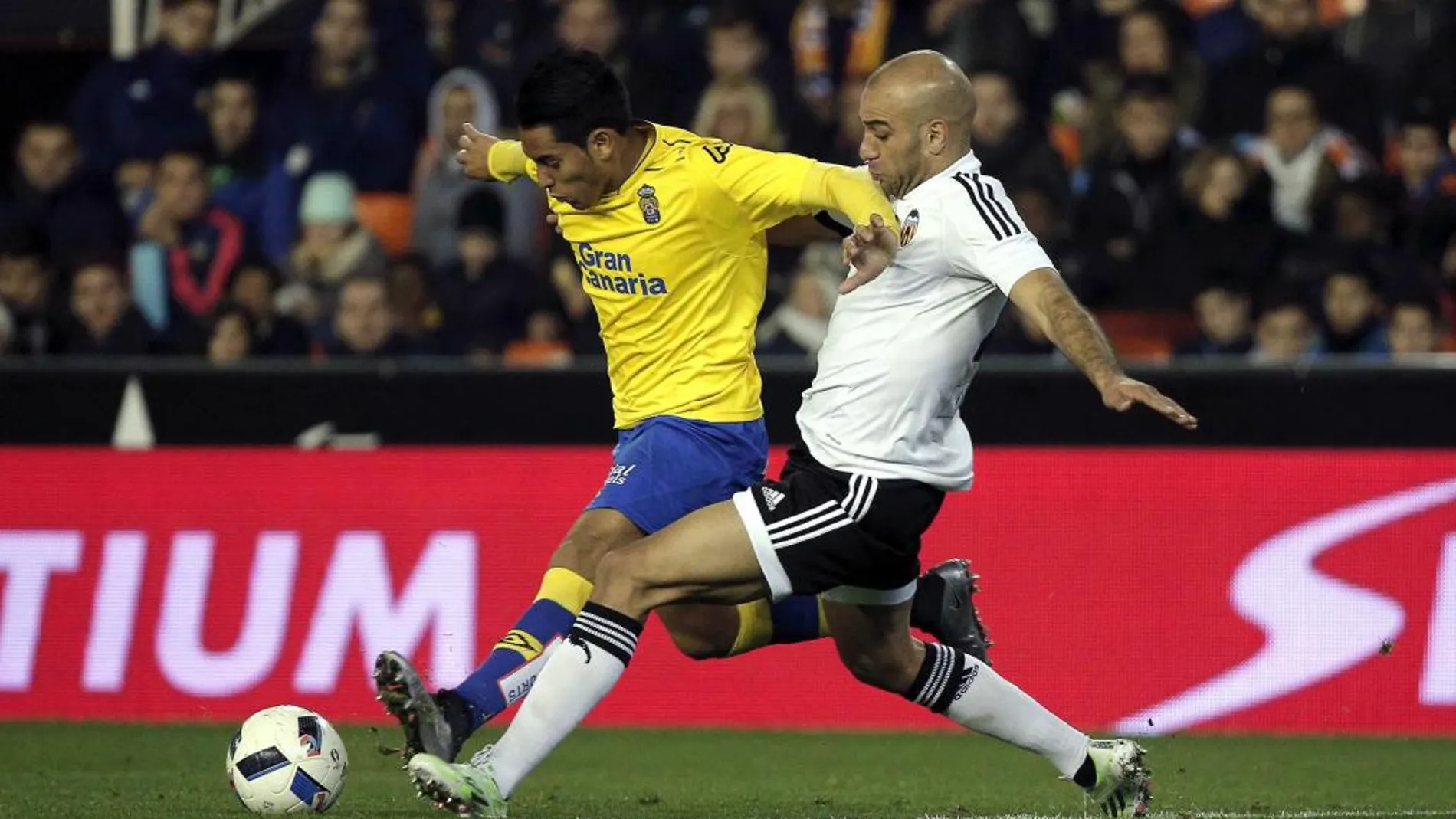 El defensa tunecino del Valencia Aymen Abdennour (d) y el delantero argentino de Las Palmas Sergio Ezequiel Araujo, luchan por el balón durante el partido