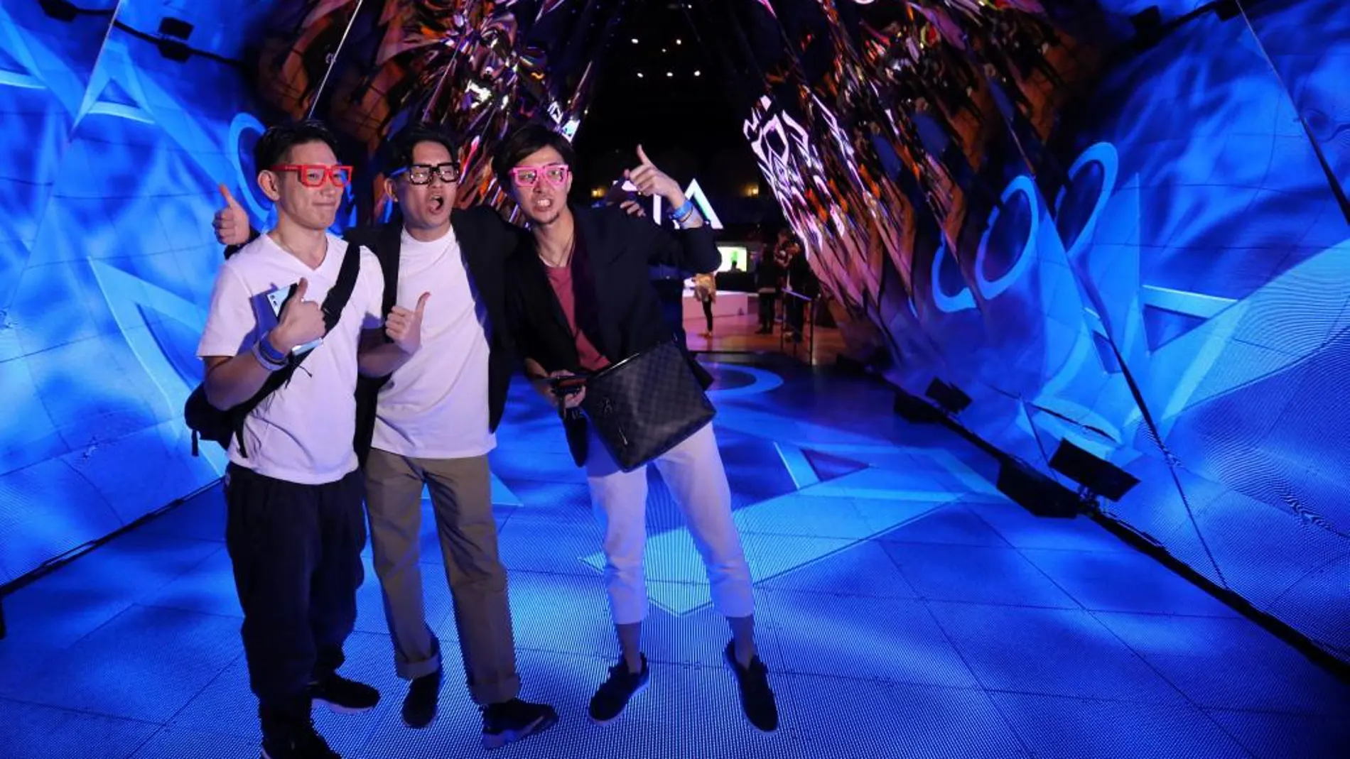 Visitantes japoneses se hacen una foto en uno de los stands de la E3