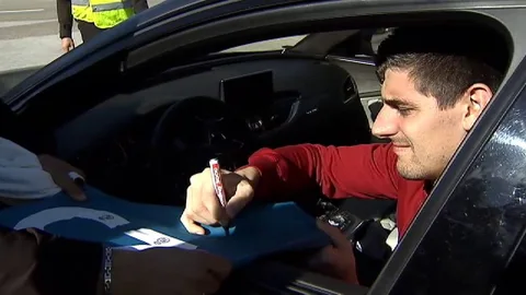 Courtois, firmando a los aficionados.