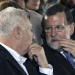Mariano Rajoy conversa con el ministro de Asuntos Exteriores, José Manuel Garcia Margallo, en el mitin celebrado hoy en Alicante, donde ha informado de que un policía español ha fallecido en Kabul