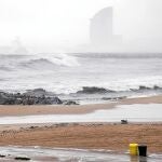 Imagen de la playa de la Barcelona, ayer, cuando la Guardia Urbana custodiaba los accesos ante el fuerte oleaje
