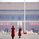 Dos de las guías turísticas de los delegados en el congreso chino hacen turismo ayer en la Plaza de Tiananmen y se fotografian ante el retrato de Mao Zedong. En la otra imagen, el nuevo primer ministro chino, Li Keqiang