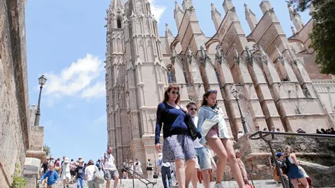 Turistas y paseantes junto a la catedral de Palma