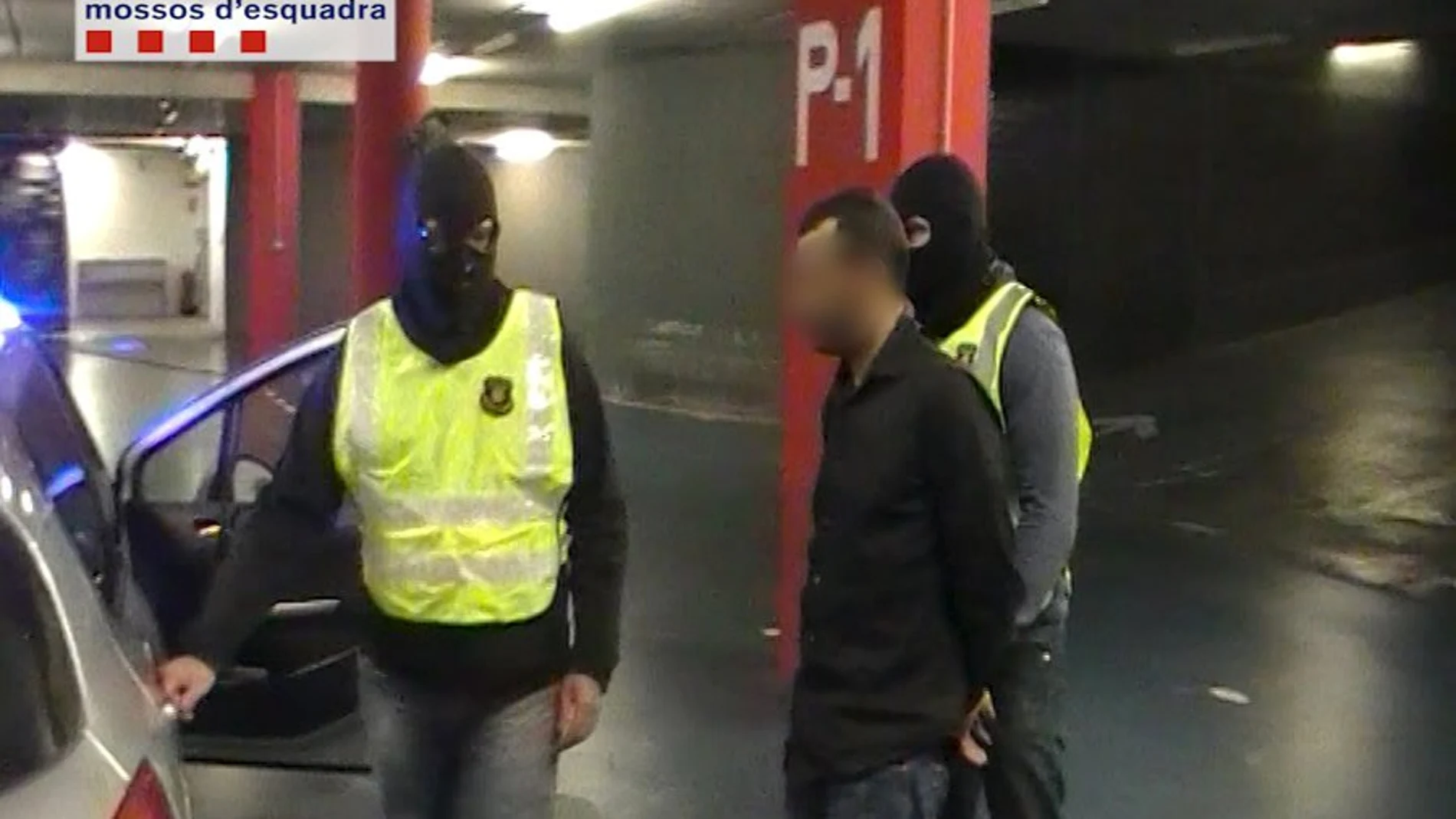 Los agentes de los Mossos d'Esquadra conducen al terrorista detenido.