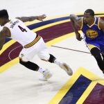 Kevin Durant de Golden State Warriors disputa el balón con Iman Shumpert de Cleveland Cavaliers
